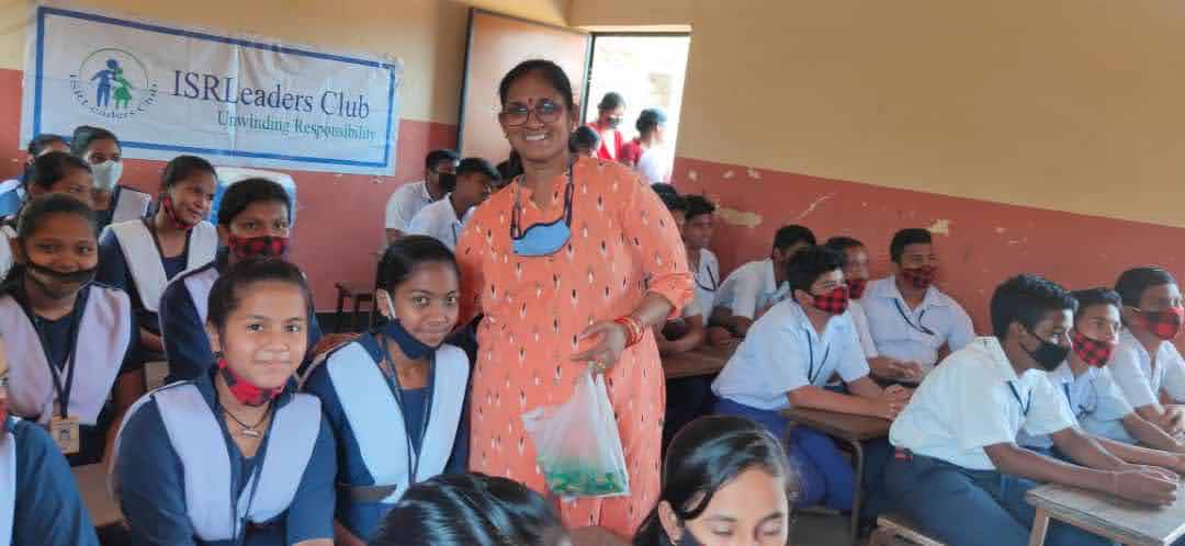 Smt. Rohini Subudhi distributing chocolates among the children